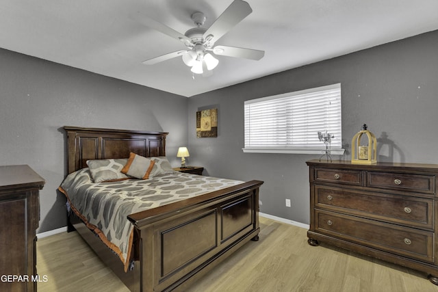 bedroom with light hardwood / wood-style flooring and ceiling fan