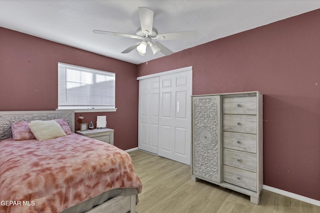 bedroom featuring ceiling fan, a closet, and light hardwood / wood-style flooring