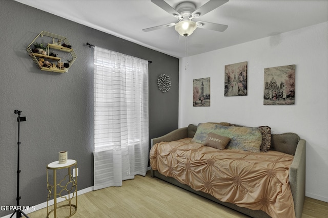 bedroom with ceiling fan and light hardwood / wood-style floors