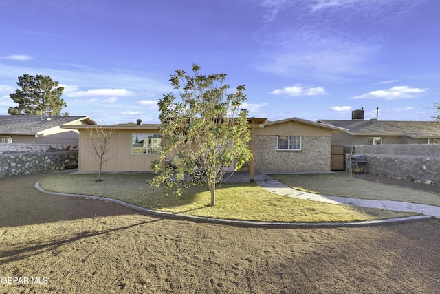 rear view of property featuring a lawn