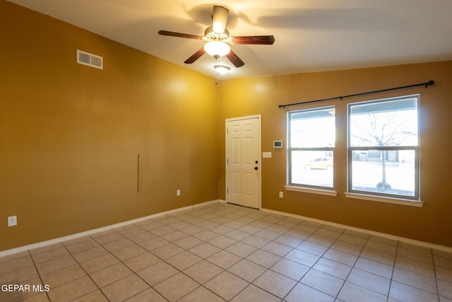 tiled spare room with ceiling fan and lofted ceiling