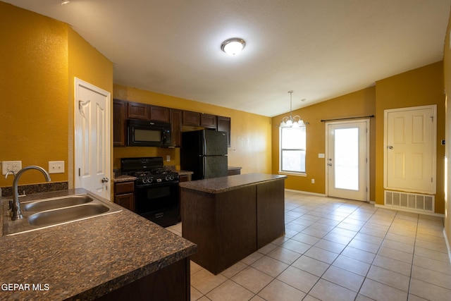 kitchen with dark brown cabinets, vaulted ceiling, sink, black appliances, and a kitchen island