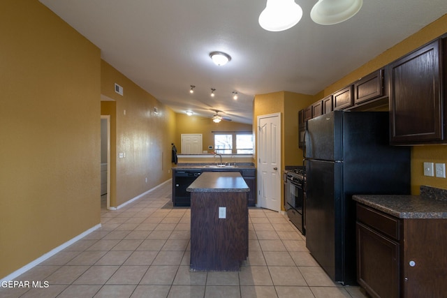 kitchen featuring sink, black appliances, a kitchen island, lofted ceiling, and light tile patterned flooring