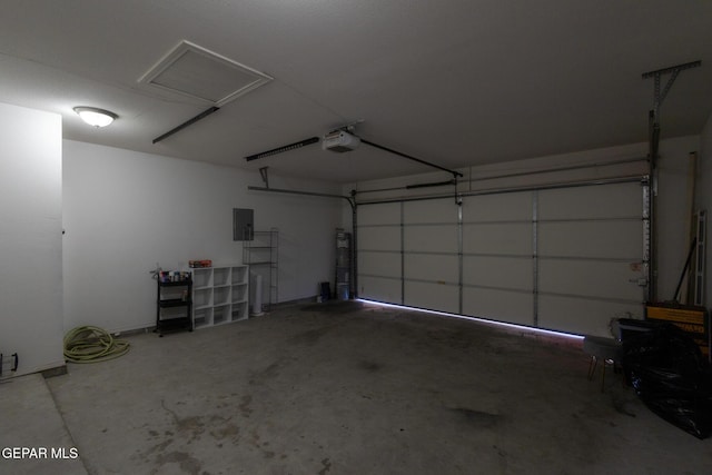 garage with electric panel and a garage door opener