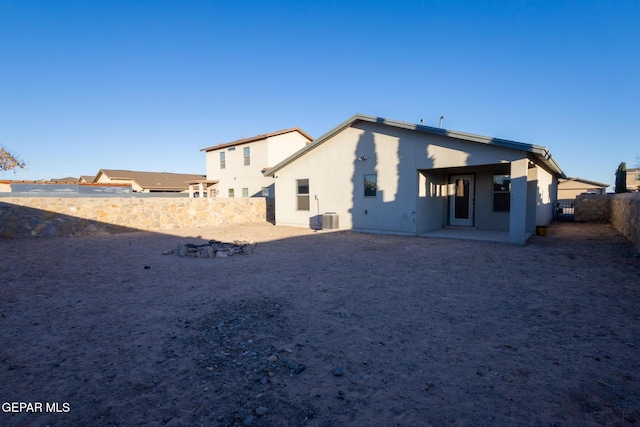 rear view of property with central AC unit