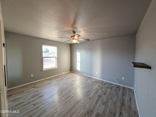 unfurnished room featuring ceiling fan, a textured ceiling, and light hardwood / wood-style flooring