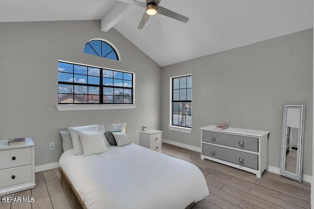 bedroom with light wood finished floors, ceiling fan, lofted ceiling with beams, and baseboards