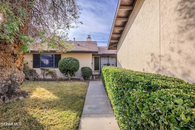 entrance to property with a yard