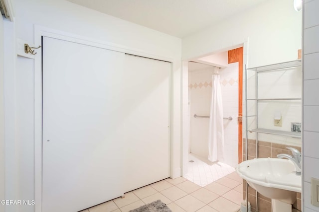 bathroom with tile patterned flooring and sink