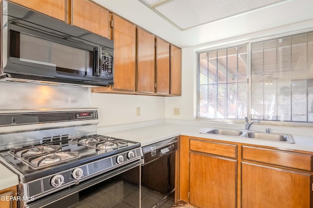 kitchen featuring sink, black appliances, and tile patterned flooring