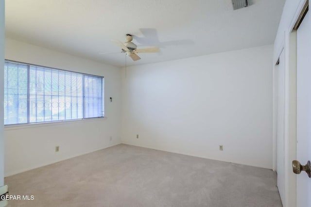 unfurnished bedroom with light carpet and ceiling fan