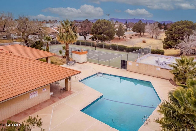 view of pool featuring a mountain view and a patio