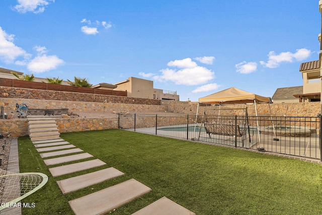 view of yard with a fenced in pool and a patio area