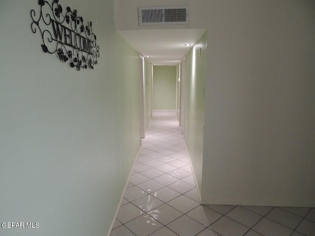 hall with light tile patterned floors