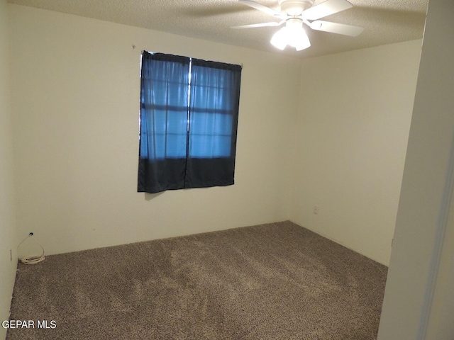 carpeted empty room featuring a textured ceiling and ceiling fan