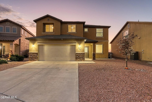 view of front of property featuring central AC and a garage