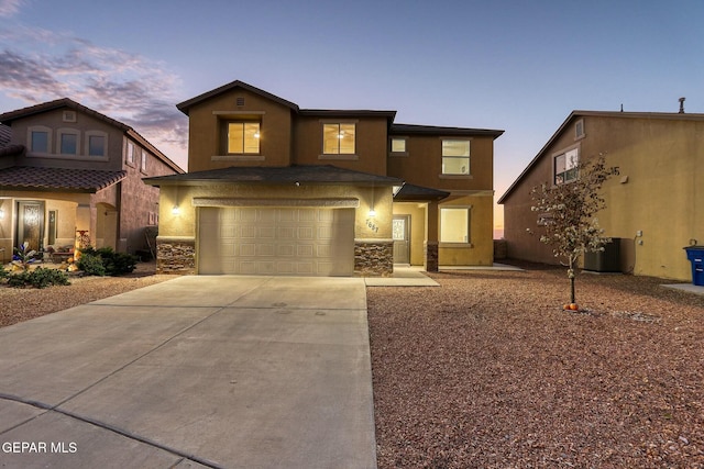 view of front of home featuring central AC and a garage