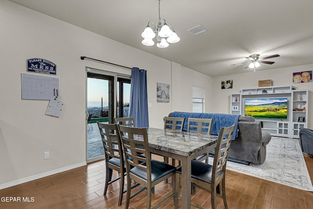 dining room featuring ceiling fan with notable chandelier