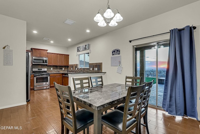 dining area featuring a notable chandelier and sink