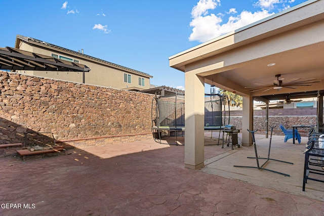 view of patio / terrace with ceiling fan and a trampoline