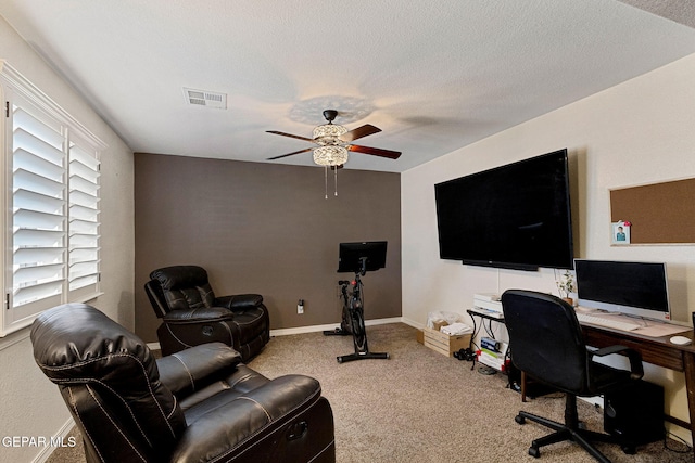 office featuring carpet flooring, ceiling fan, and a textured ceiling