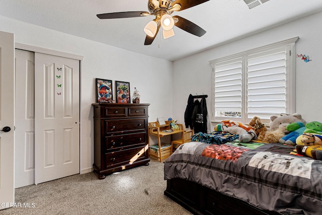 bedroom with ceiling fan and a closet