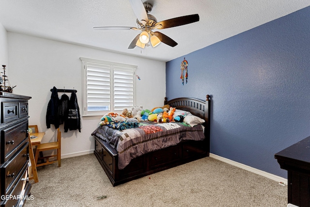 carpeted bedroom featuring a textured ceiling and ceiling fan