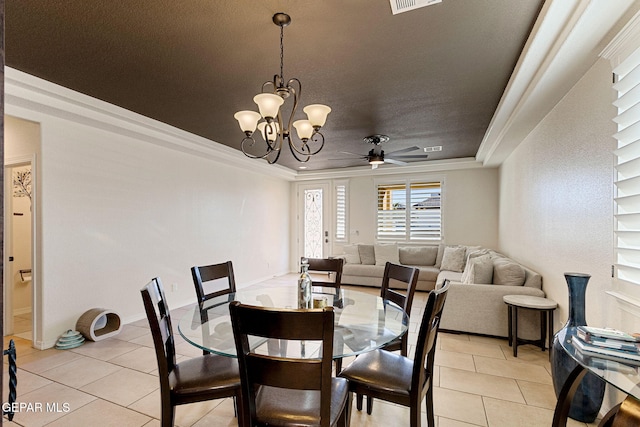 tiled dining room featuring ceiling fan with notable chandelier, a raised ceiling, and ornamental molding