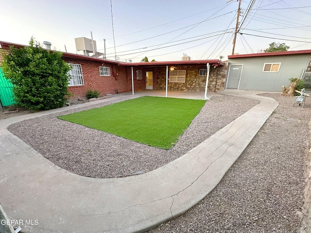 rear view of property with a lawn