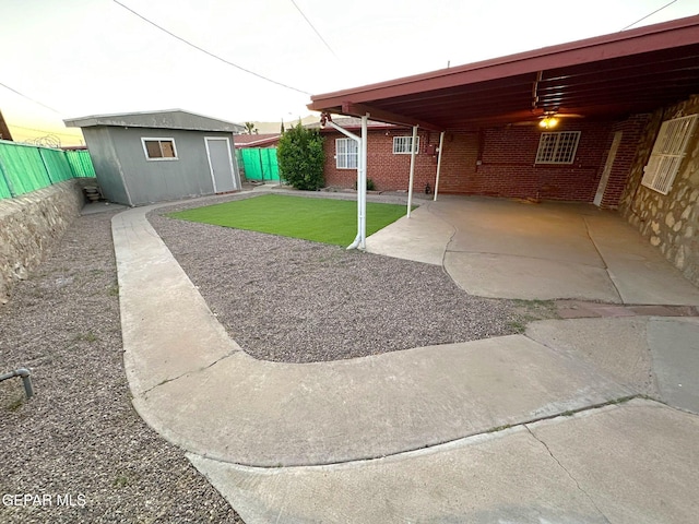 view of yard with a carport and an outbuilding