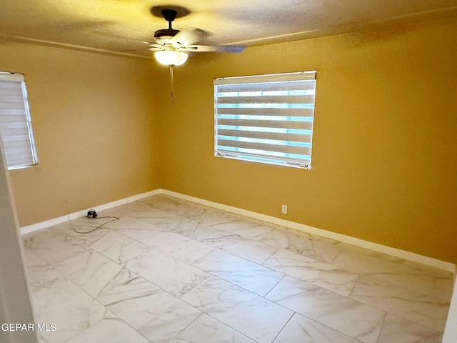 spare room with ceiling fan and a textured ceiling