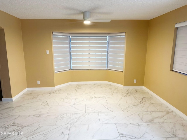 unfurnished room with a textured ceiling