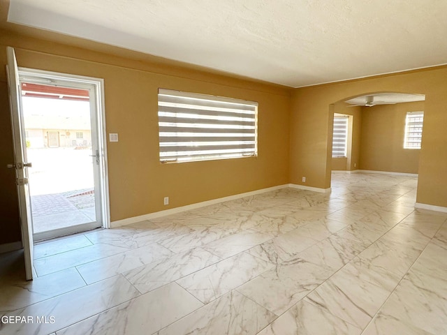 spare room with a textured ceiling