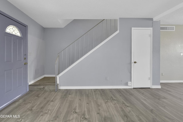 foyer with light hardwood / wood-style floors