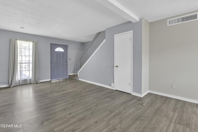 entrance foyer featuring hardwood / wood-style flooring and a textured ceiling