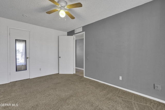 spare room with a textured ceiling, carpet floors, and ceiling fan