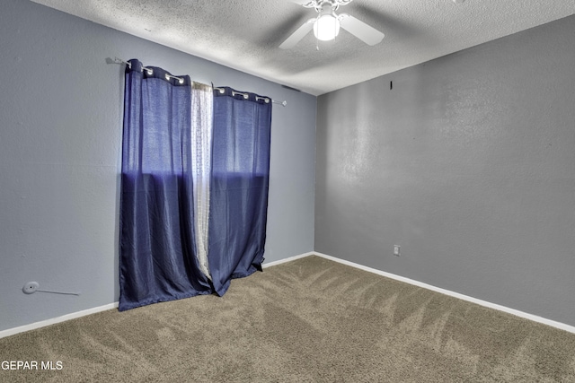 carpeted empty room featuring ceiling fan and a textured ceiling