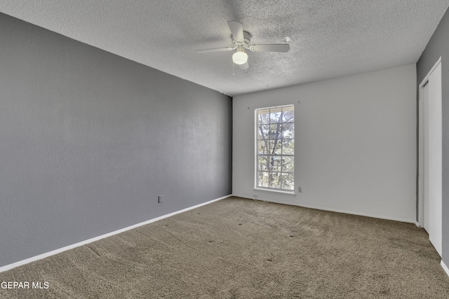 empty room featuring carpet, a textured ceiling, and ceiling fan