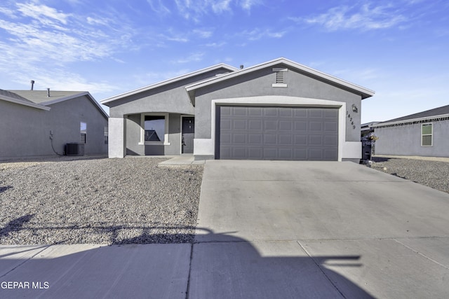 view of front of property featuring central AC unit and a garage