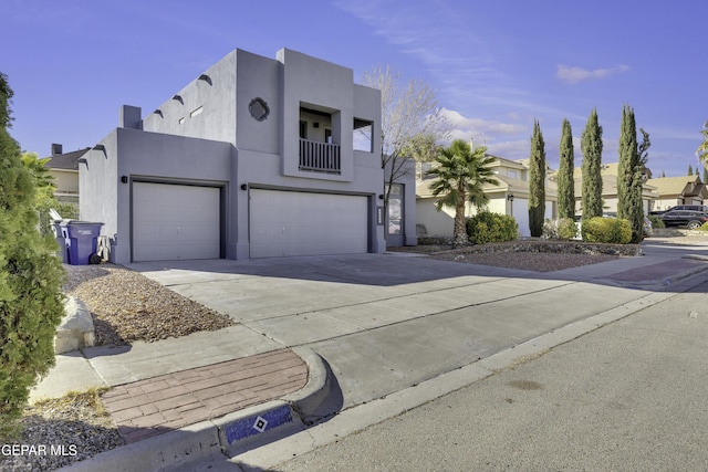 view of front of house featuring a balcony and a garage