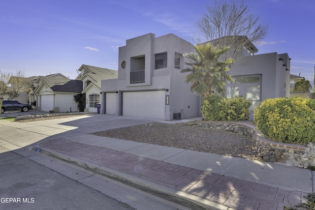 view of front of property featuring a garage and a balcony