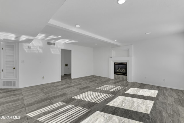 unfurnished living room featuring beamed ceiling