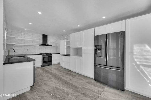 kitchen with white cabinetry, sink, wall chimney exhaust hood, decorative backsplash, and appliances with stainless steel finishes