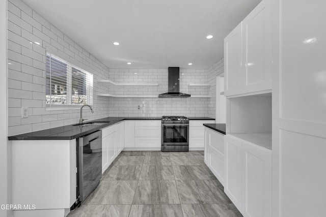 kitchen featuring white cabinets, wall chimney range hood, sink, and stainless steel range