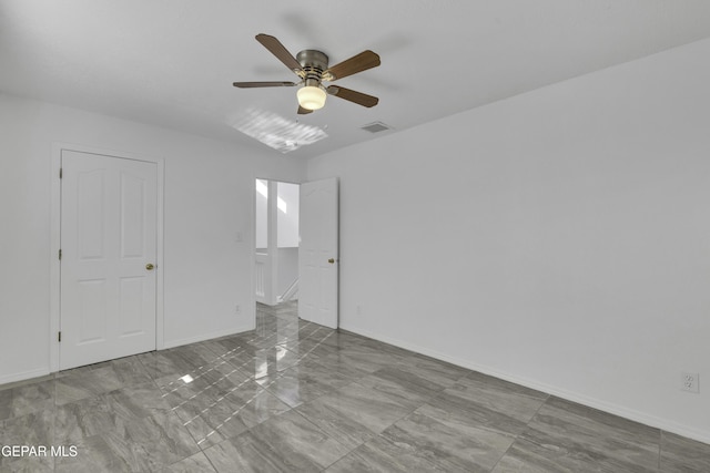 spare room with ceiling fan