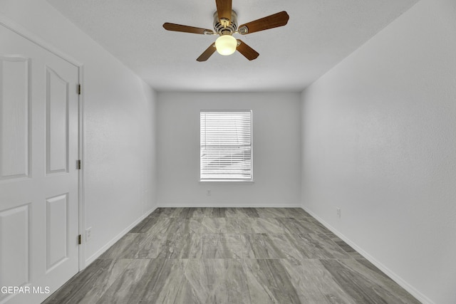 spare room with ceiling fan