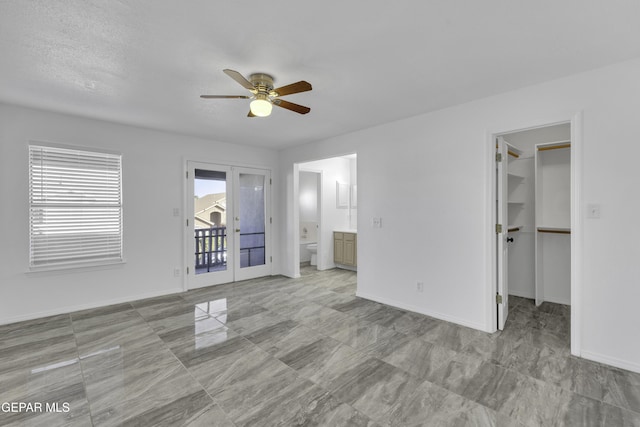 interior space with french doors, ceiling fan, access to exterior, a spacious closet, and a closet