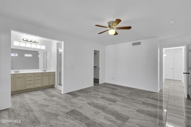 interior space featuring ceiling fan and sink