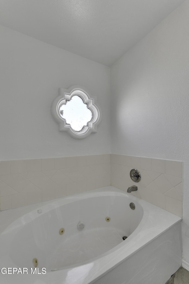 bathroom with a tub to relax in