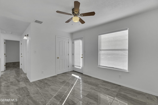 spare room with ceiling fan